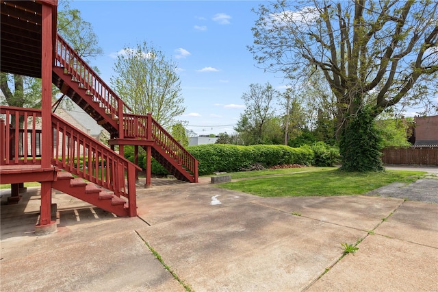 view of yard with stairway, fence, and a patio area