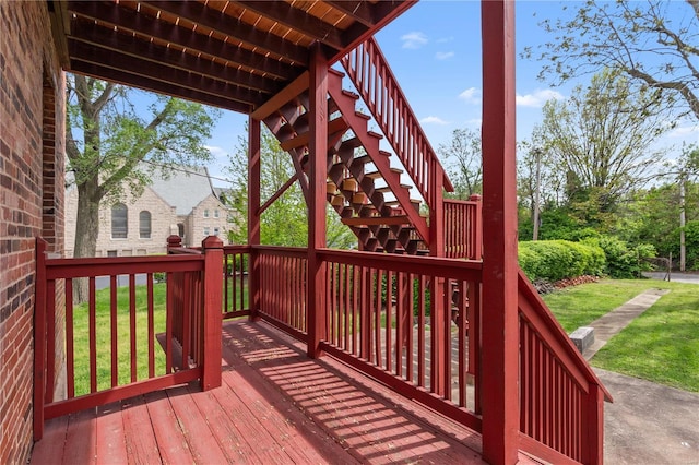 deck with stairs and a yard