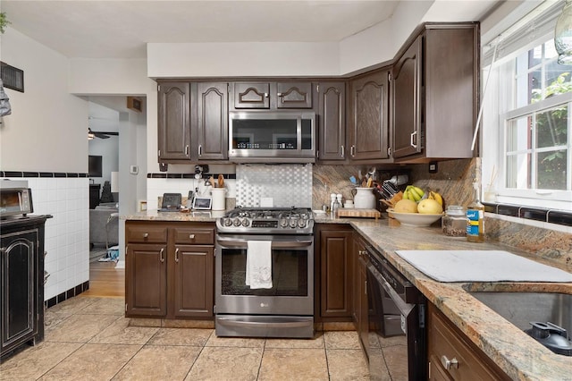 kitchen with a healthy amount of sunlight, dark brown cabinetry, and stainless steel appliances