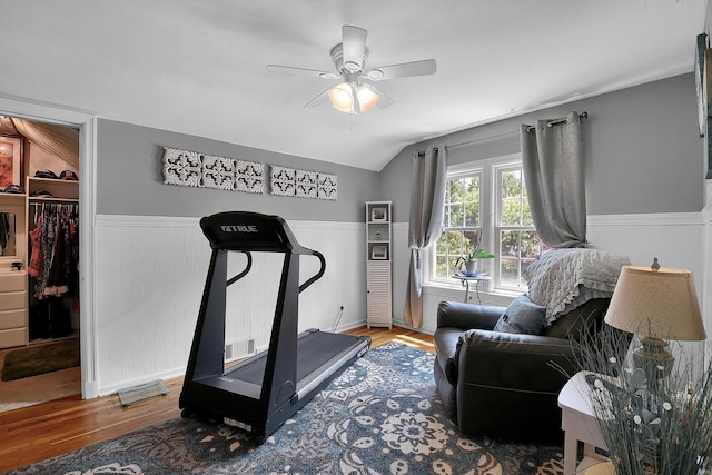exercise room with wainscoting and wood finished floors