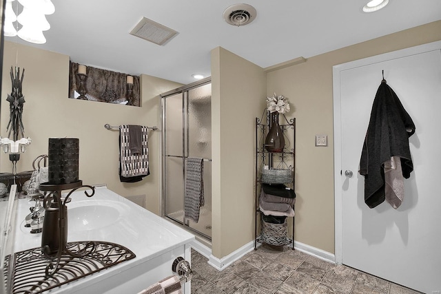 full bathroom with baseboards, a stall shower, recessed lighting, and visible vents
