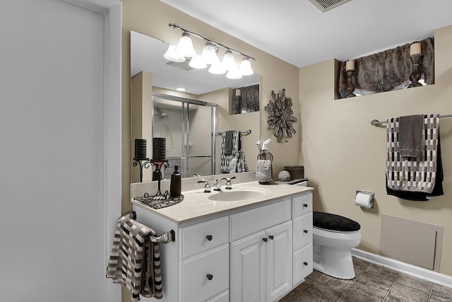 bathroom featuring vanity, baseboards, a shower stall, and toilet