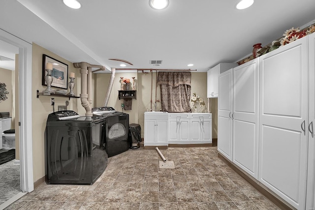 laundry room featuring washer and dryer, cabinet space, a sink, recessed lighting, and visible vents