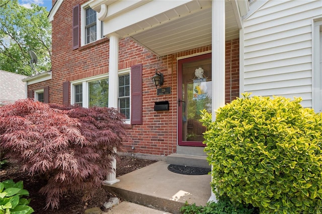 property entrance featuring brick siding