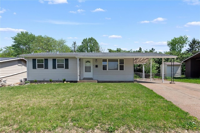 ranch-style home featuring an outdoor structure, a front lawn, a storage shed, a carport, and driveway