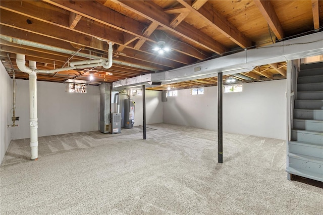 below grade area with heating unit, carpet floors, gas water heater, and stairs