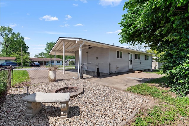 exterior space with fence, a gate, entry steps, and a carport