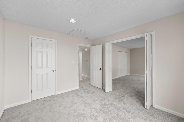 unfurnished bedroom featuring baseboards, a textured ceiling, and carpet