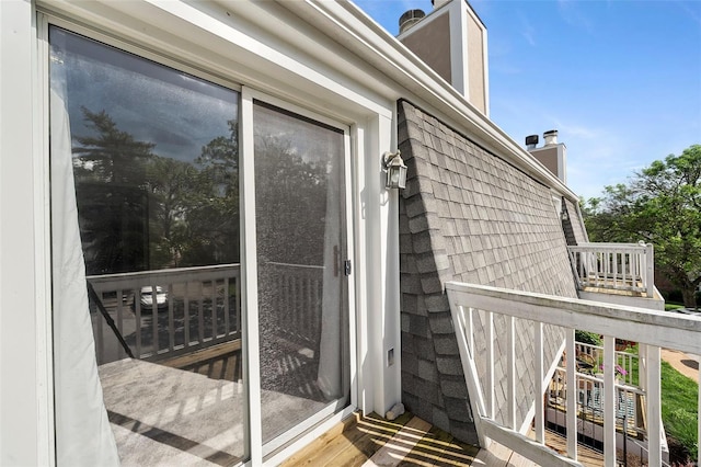 view of exterior entry featuring a chimney
