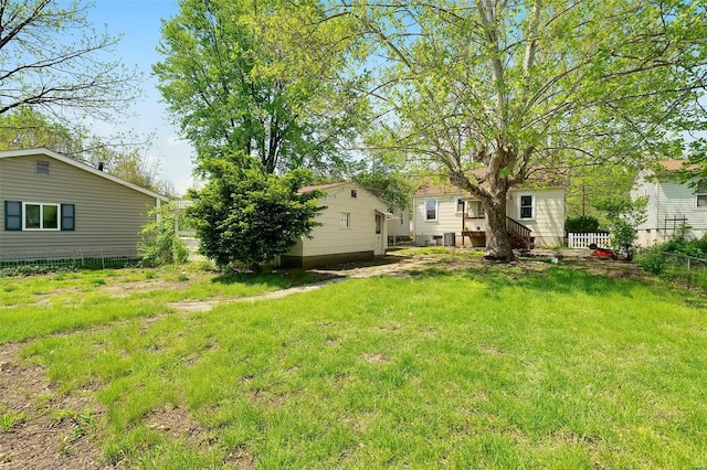 view of yard with fence and central air condition unit