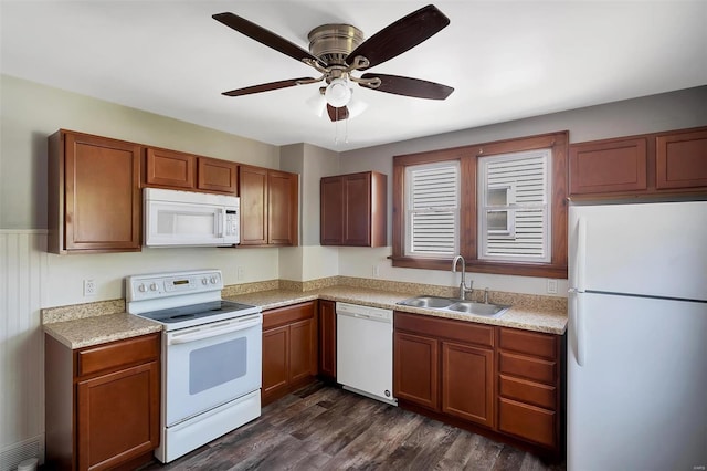 kitchen with white appliances, ceiling fan, dark wood-style floors, light countertops, and a sink