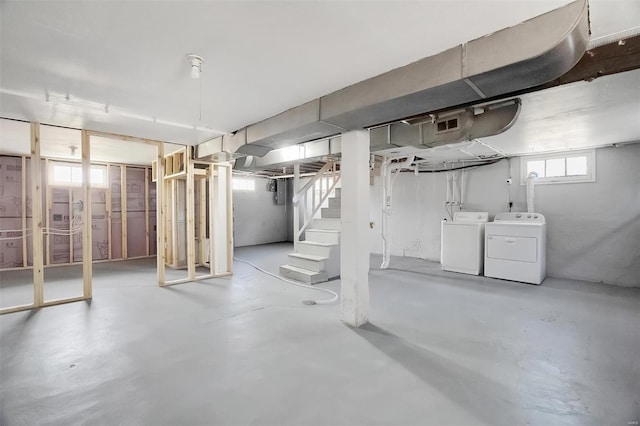 below grade area with washer and clothes dryer and stairway