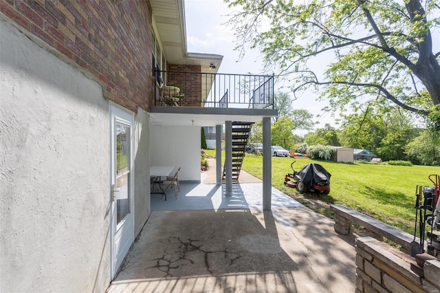 view of patio with stairs, an outdoor structure, and a storage shed