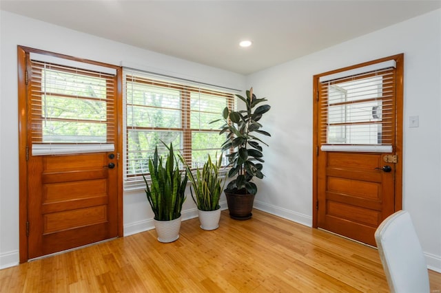 entryway featuring baseboards, recessed lighting, and light wood finished floors