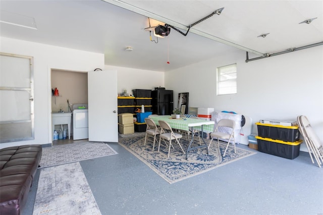 garage with a garage door opener, washer / dryer, and freestanding refrigerator