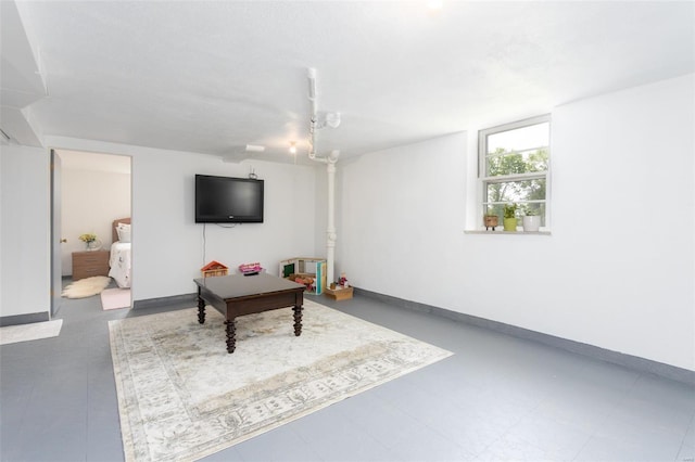 living area featuring baseboards