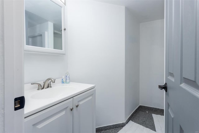 bathroom with vanity and baseboards
