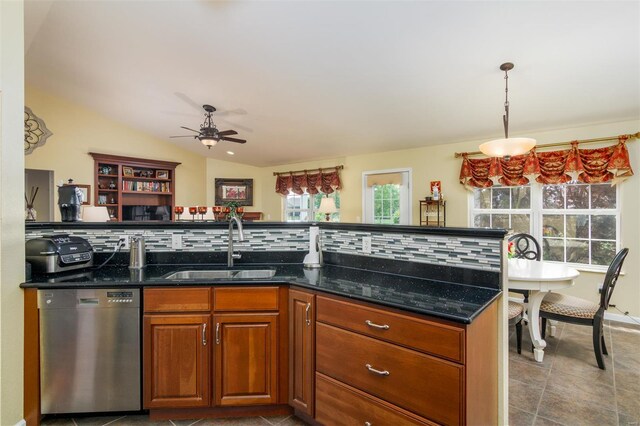 kitchen with a healthy amount of sunlight, backsplash, a ceiling fan, dishwasher, and a sink