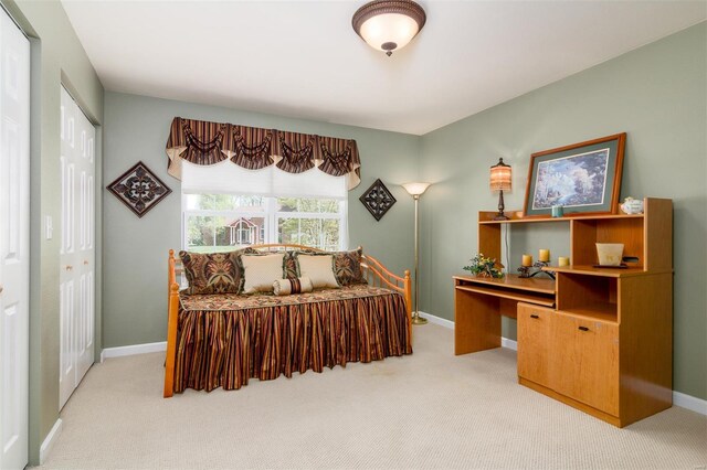 carpeted bedroom with baseboards and a closet