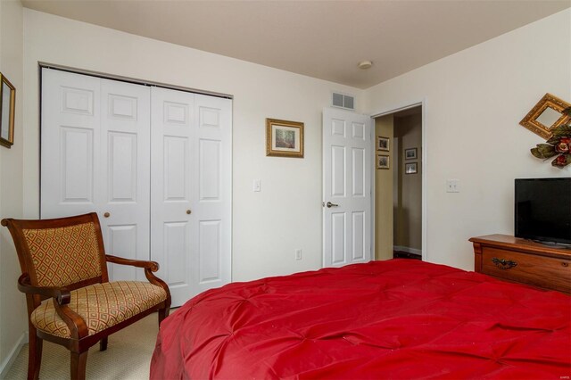bedroom featuring carpet floors, a closet, and visible vents