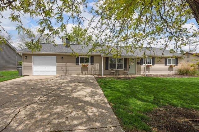 ranch-style house with an attached garage, a front lawn, driveway, and a chimney