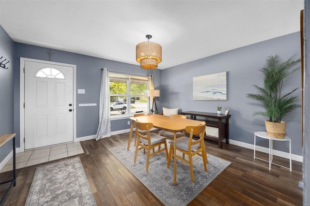 dining area featuring baseboards and wood finished floors