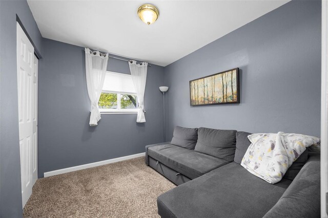 carpeted living room with baseboards
