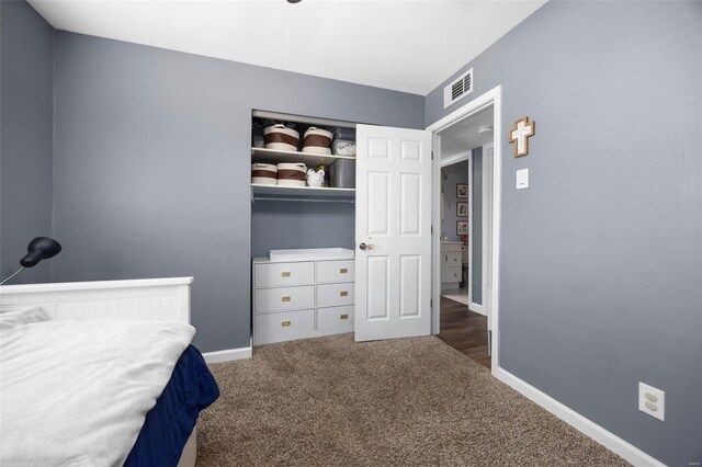 carpeted bedroom with baseboards and visible vents