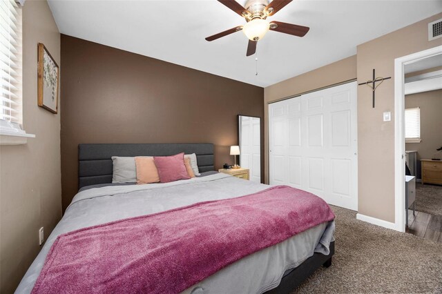 bedroom with carpet flooring, ceiling fan, baseboards, visible vents, and a closet