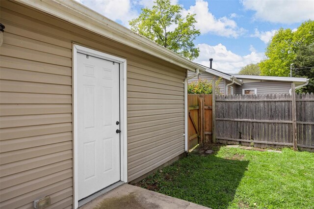 view of outbuilding featuring fence and an outbuilding