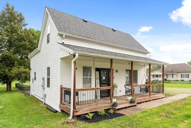 view of front of property with roof with shingles, a porch, and a front lawn