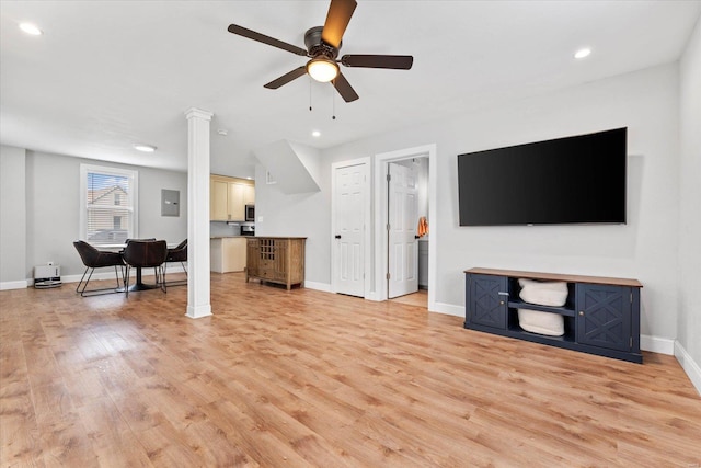 living room with a ceiling fan, decorative columns, recessed lighting, and light wood-style flooring