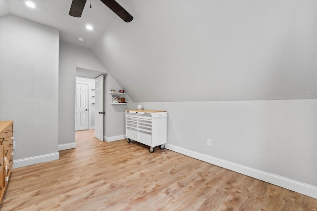 bonus room featuring baseboards, ceiling fan, vaulted ceiling, and light wood-style flooring