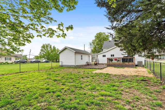 back of house with a lawn, a fenced backyard, a wooden deck, and central air condition unit