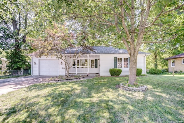 view of front facade with fence, a garage, a front yard, covered porch, and driveway