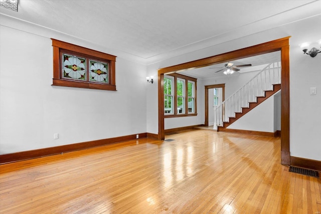 unfurnished living room with baseboards, visible vents, and light wood-type flooring