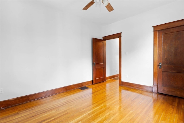 unfurnished room featuring baseboards, ceiling fan, light wood-style flooring, and visible vents