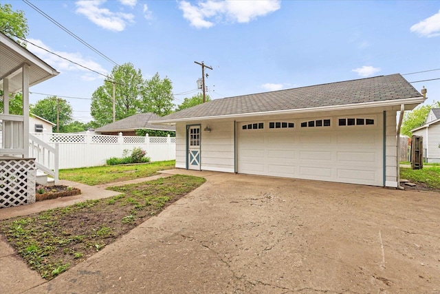 ranch-style house featuring an outdoor structure, a garage, and fence