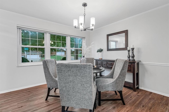 dining room with baseboards, a chandelier, ornamental molding, and wood finished floors