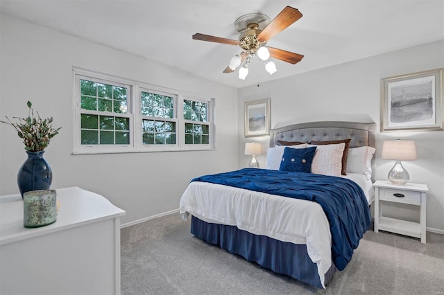 carpeted bedroom with a ceiling fan and baseboards