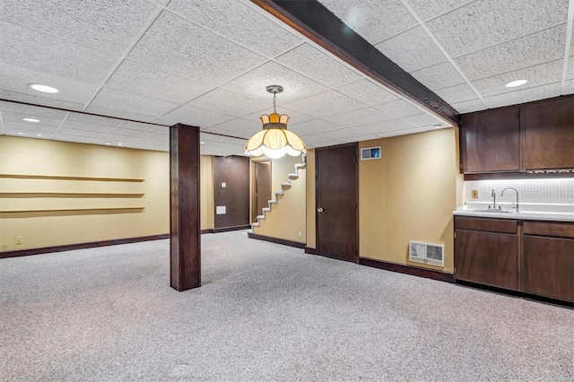 finished below grade area featuring visible vents, carpet floors, baseboards, stairway, and recessed lighting