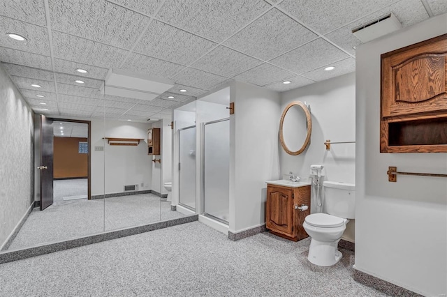 bathroom featuring toilet, baseboards, and a shower stall
