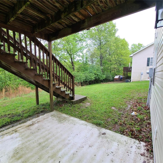 view of yard featuring a patio area and stairway