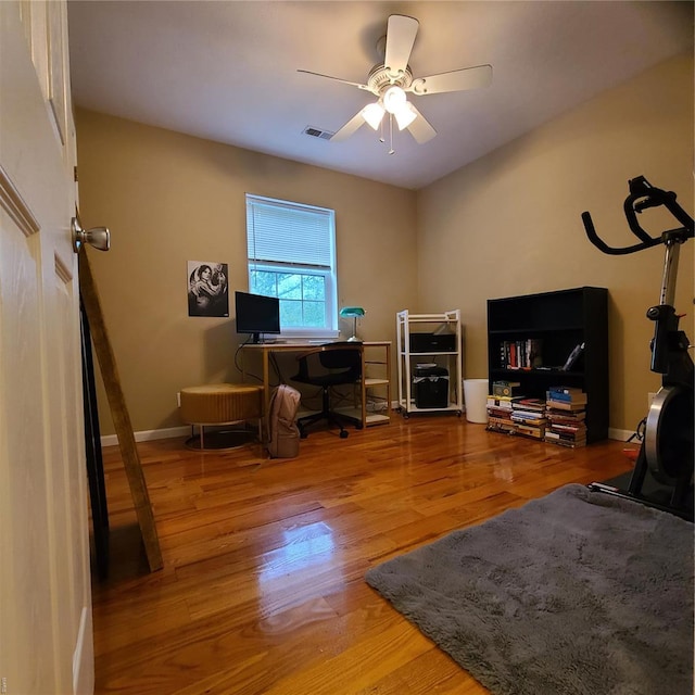 office with visible vents, baseboards, ceiling fan, and wood finished floors
