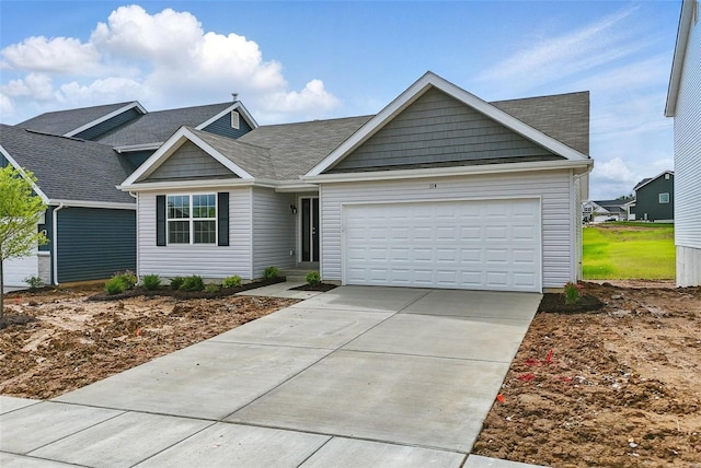 ranch-style home featuring a shingled roof, an attached garage, and concrete driveway