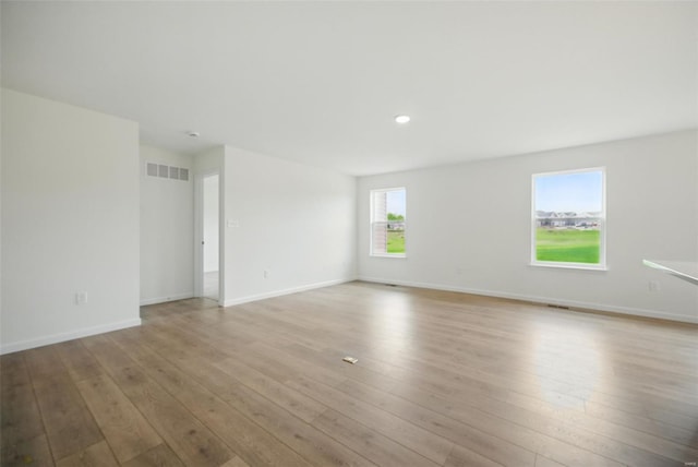 unfurnished room with light wood-style floors, recessed lighting, baseboards, and visible vents