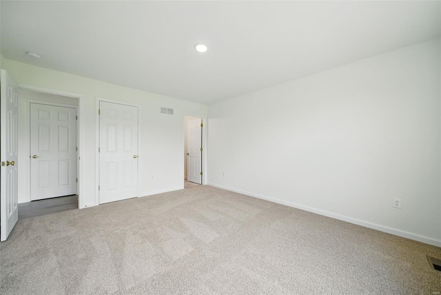 unfurnished bedroom with baseboards, carpet flooring, recessed lighting, and visible vents