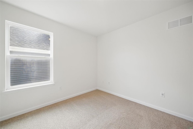 unfurnished room featuring visible vents, baseboards, and carpet floors