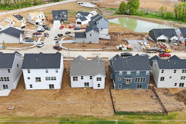 drone / aerial view featuring a water view and a residential view