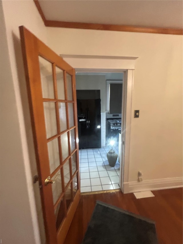 corridor featuring french doors and crown molding